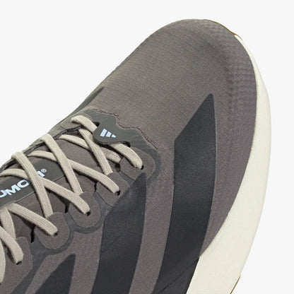adidas adizero EVO SL. Close-up of Charcoal woven upper showing light grey laces, light blue accent loop, and dark three-stripes.