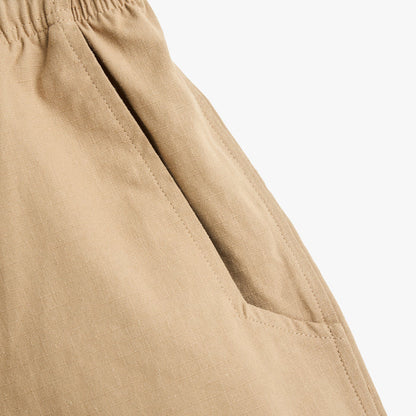 Brother Brother Ripstop Baggie Shorts. Close-up of khaki shorts showing angled side pocket, stitched seams and ripstop texture.