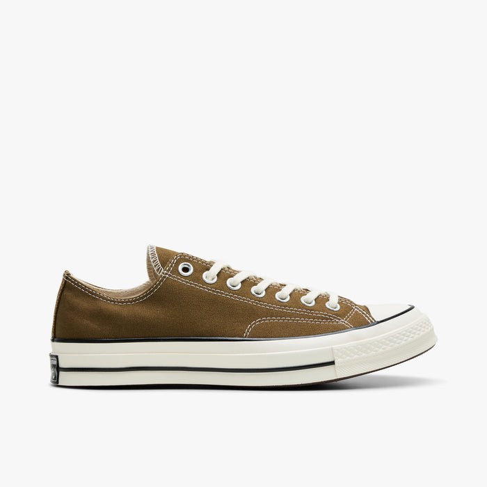 Converse Chuck 70 Canvas. Side view of bog down canvas sneakers with white laces, rubber toe cap, and egret midsole.