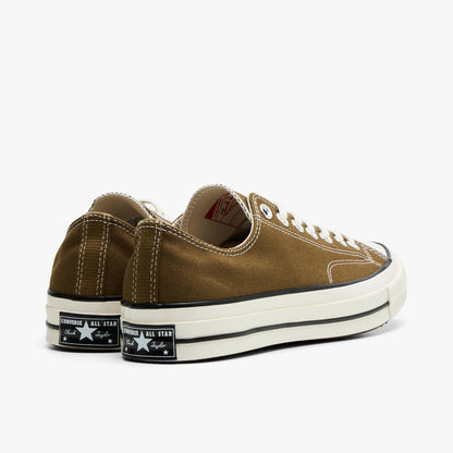 Converse Chuck 70 Canvas. Rear view of bog down canvas sneakers showing black heel logo patch and egret rubber midsole.