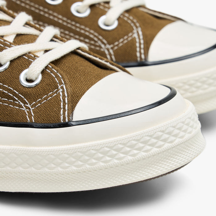 Converse Chuck 70 Canvas. Close-up of the rubber toe cap and egret midsole on bog down canvas sneakers.