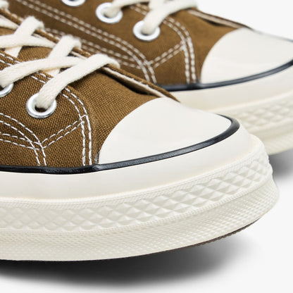 Converse Chuck 70 Canvas. Close-up of the rubber toe cap and egret midsole on bog down canvas sneakers.
