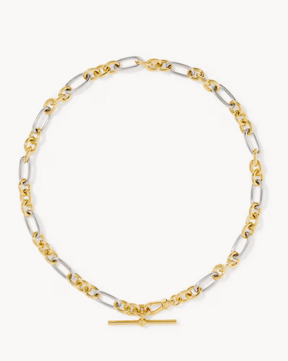 A two-tone mixed metal link chain necklace with elongated oval links in yellow gold and silver-tone metal, featuring a small horizontal bar clasp at the bottom, displayed on a light gray background.