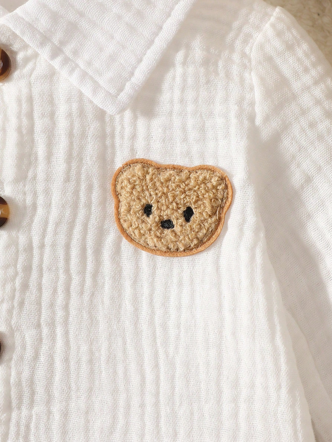 Newborn White Long-Sleeve Collared Shirt With A Small Bear Design, Paired With Apricot-Colored Pants