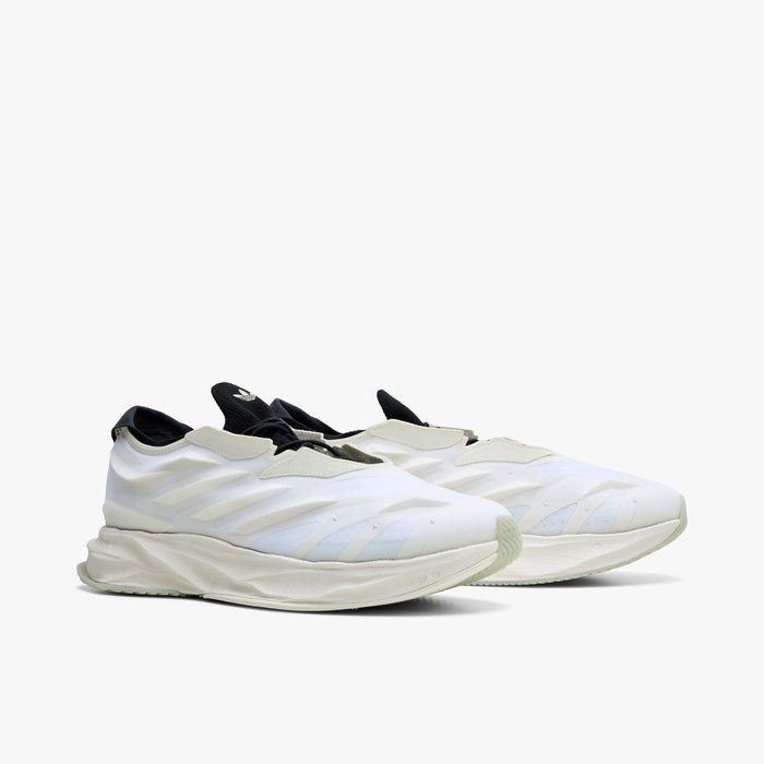 adidas Terra Mono. Three-quarter view of white, off white and black sneakers with black laces, sculpted uppers and thick soles.
