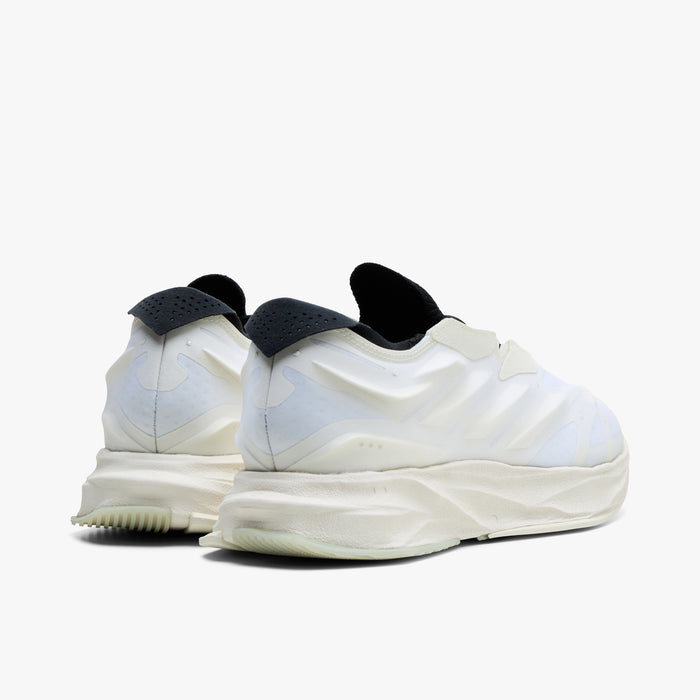 adidas Terra Mono. Rear three-quarter view of white, off white and black sneakers with black collars, rounded heels and layered soles.