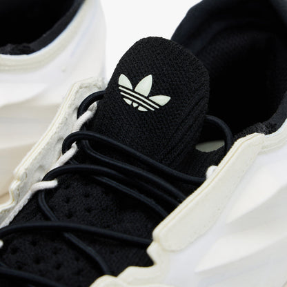 adidas Terra Mono. Close-up of white, off white and black sneaker showing black laces, black tongue with adidas Trefoil and sculpted upper.