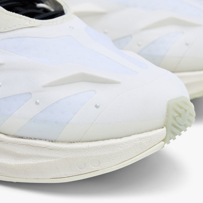 adidas Terra Mono. Close-up of white, off white and black sneaker showing layered toe panels and textured off white sole.