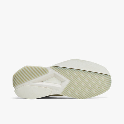 adidas Terra Mono. Bottom view of white, off white and black sneaker showing off white outsole with geometric tread pattern.