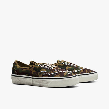 Vans LX Authentic 44. Three-quarter view of woodland camo sneakers showing studded toe vamps and cream laces.