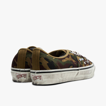 Vans LX Authentic 44. Rear view of woodland camo sneakers showing red heel logo patch and distressed rubber midsole.