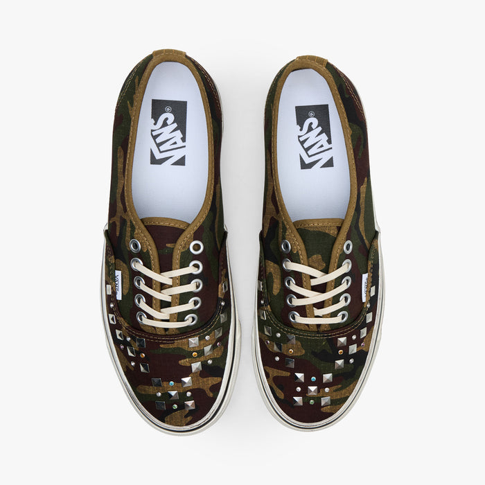 Vans LX Authentic 44. Top view of pair of woodland camo sneakers showing studded toe vamps, cream laces, and white insoles.