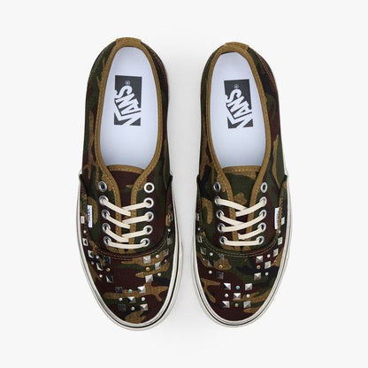 Vans LX Authentic 44. Top view of pair of woodland camo sneakers showing studded toe vamps, cream laces, and white insoles.