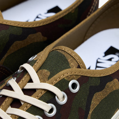 Vans LX Authentic 44. Close-up of silver eyelets, cream laces, brown canvas trim, and Vans inner heel branding.