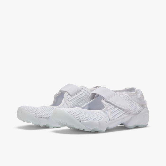 Nike Women's Air Rift Breathe. Three-quarter view of white split-toe sneakers with mesh uppers, adjustable straps and rounded soles.