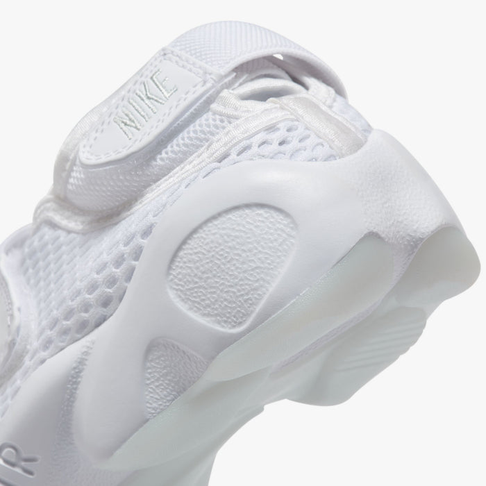 Nike Women's Air Rift Breathe. Close-up of white split-toe sneaker showing adjustable heel strap, rounded side panels and sculpted sole.