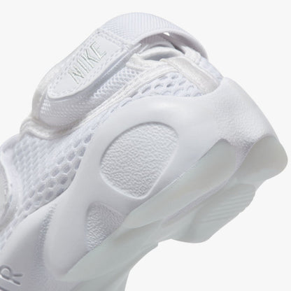 Nike Women's Air Rift Breathe. Close-up of white split-toe sneaker showing adjustable heel strap, rounded side panels and sculpted sole.