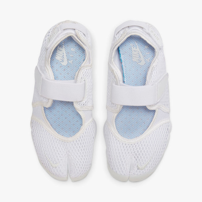 Nike Women's Air Rift Breathe. Top view of white split-toe sneakers showing mesh uppers, adjustable straps and light blue insoles.