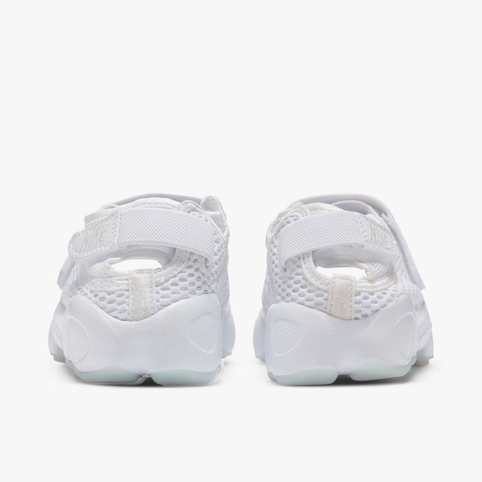 Nike Women's Air Rift Breathe. Rear view of white split-toe sneakers with adjustable heel straps, mesh panels and rounded soles.