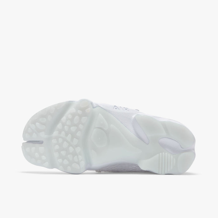 Nike Women's Air Rift Breathe. Bottom view of white split-toe sneaker showing segmented outsole with rounded tread sections.