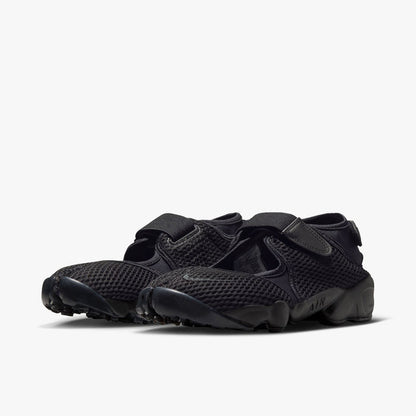 Nike Women's Air Rift Mesh. Three-quarter view of black split-toe shoes showing midfoot hook-and-loop strap and sculpted midsole with AIR written on the side.