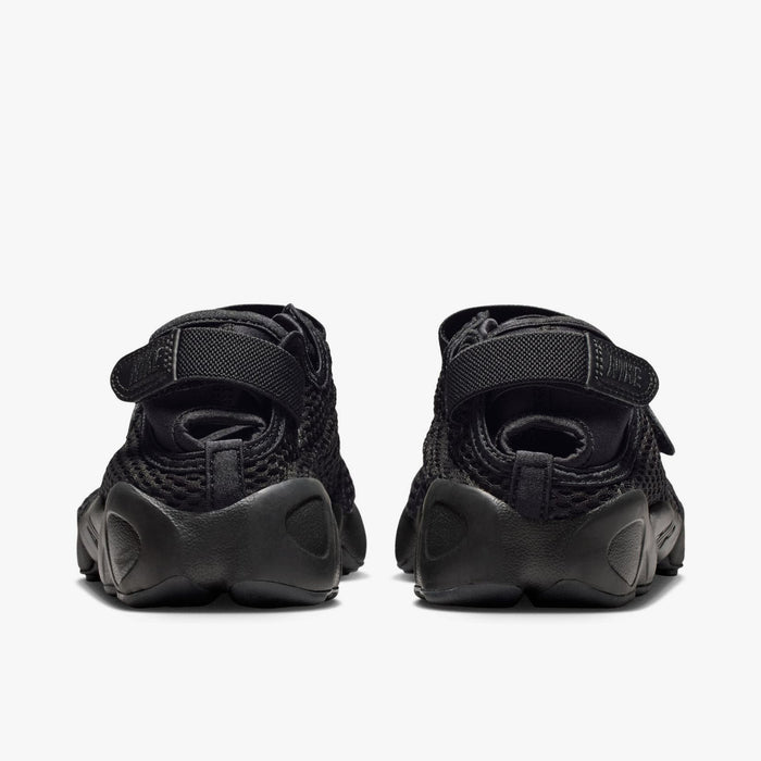 Nike Women's Air Rift Mesh. Rear view of black split-toe shoes showing adjustable heel strap closures with embroidered Nike logo hits and thick rubber midsoles.