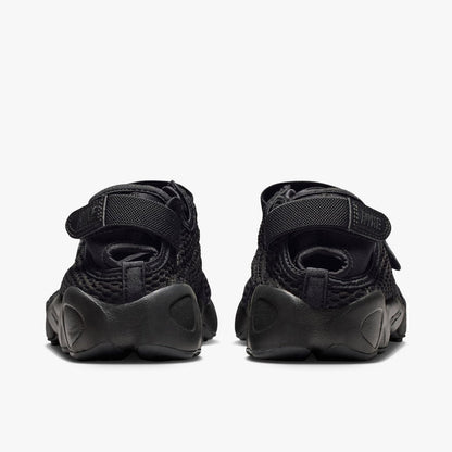 Nike Women's Air Rift Mesh. Rear view of black split-toe shoes showing adjustable heel strap closures with embroidered Nike logo hits and thick rubber midsoles.