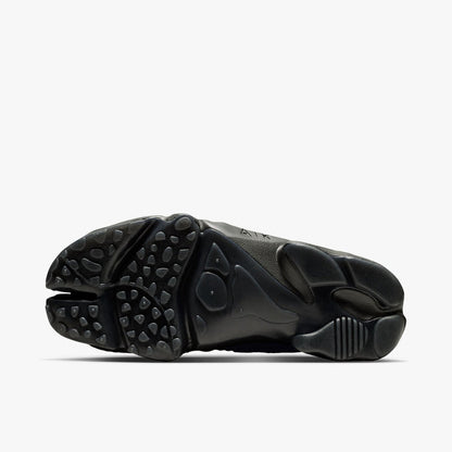 Nike Women's Air Rift Mesh. Bottom view of black split-toe shoes showing rubber traction outsole pattern and split-toe groove.